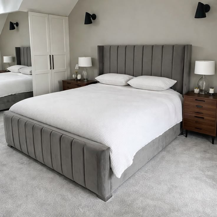 Mid-grey plush velvet wingback bed with high vertical panel headboard and white textured bedding