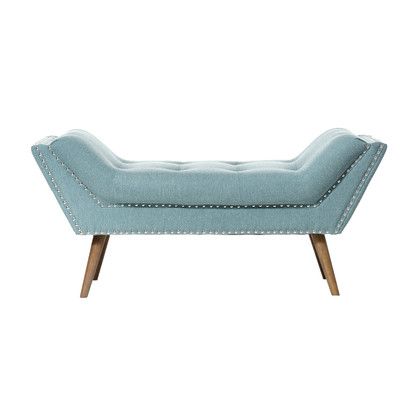A mid-century modern concave tufted accent bench in duck-egg blue linen featuring silver nailhead trim and splayed walnut legs over a white background.